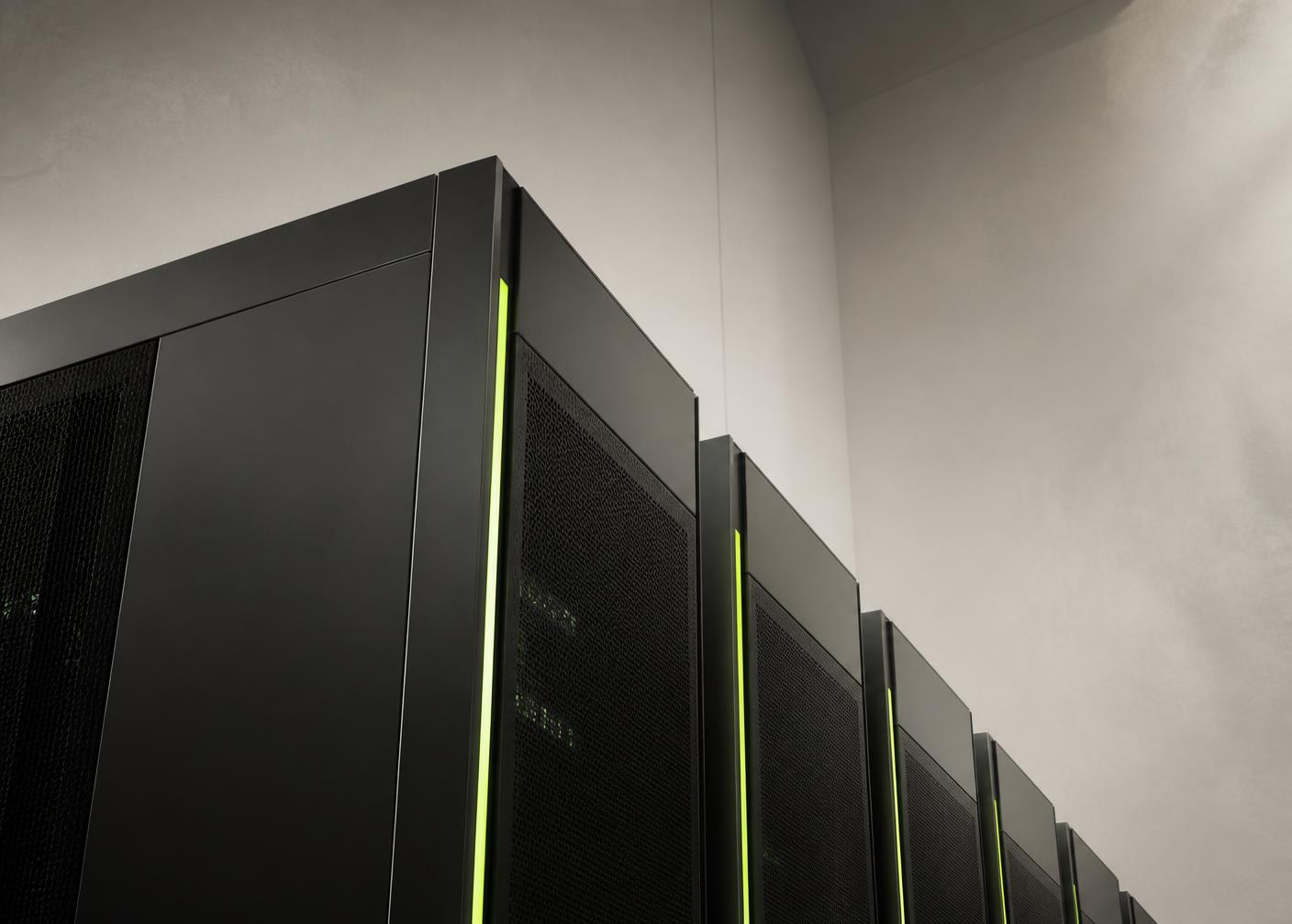 Dark server cabinets in a data hall with narrow green indicator lighting