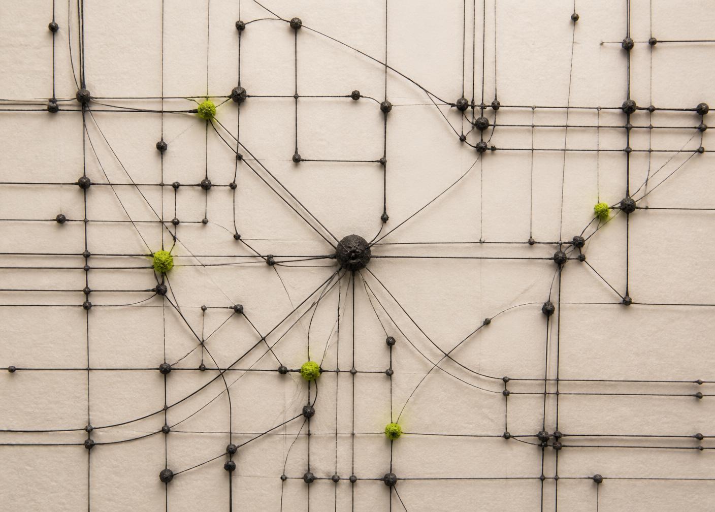 An abstract wire-and-node model of a software system arranged on textured ivory paper